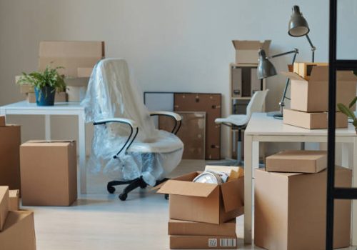 istockphoto-1459946437-612×612 Horizontal image of big light office with new furniture and unpacked cardboard boxes